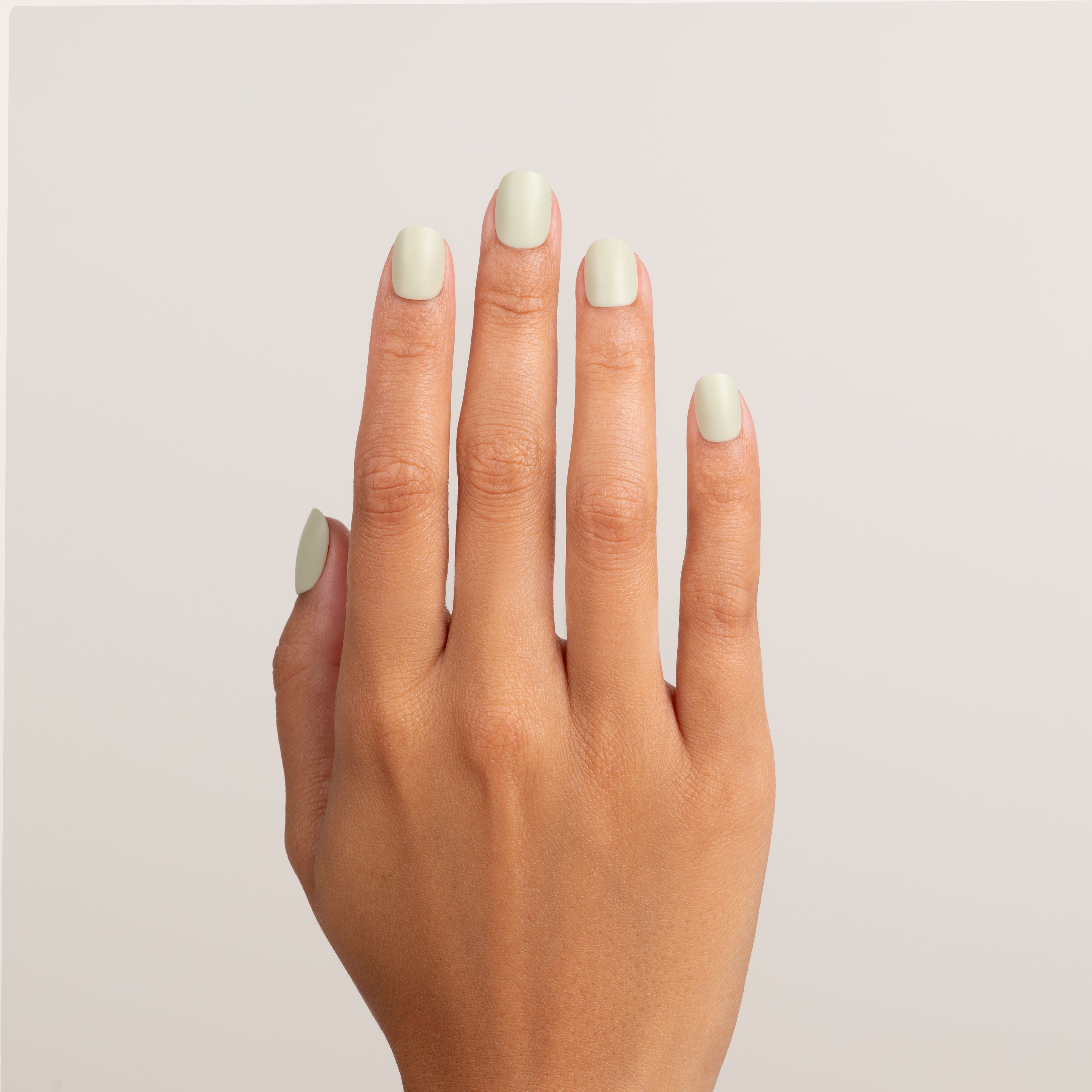 Hand with light green nails